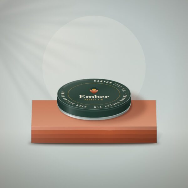 Ember pocket tin in juniper green enamel on a sandstone slab
